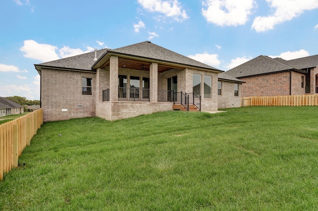 rear view of house with a yard