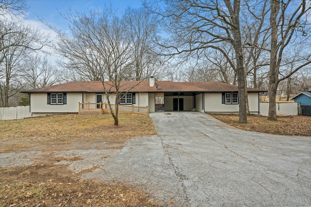 single story home featuring a carport