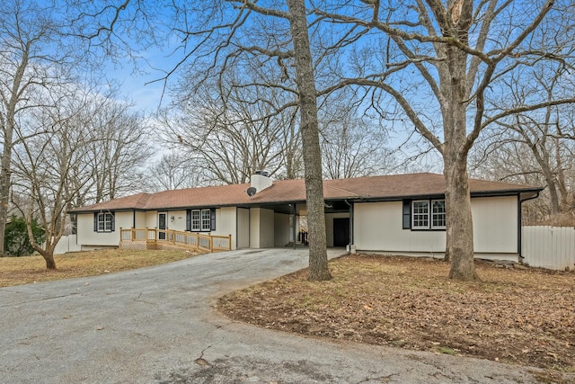 ranch-style home featuring a carport