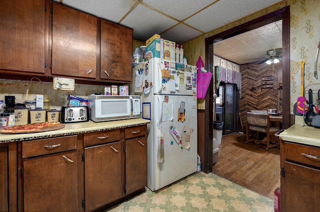 kitchen featuring ceiling fan, white appliances, and a paneled ceiling