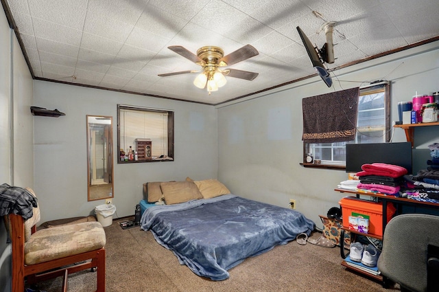 bedroom featuring ceiling fan, ornamental molding, and carpet floors