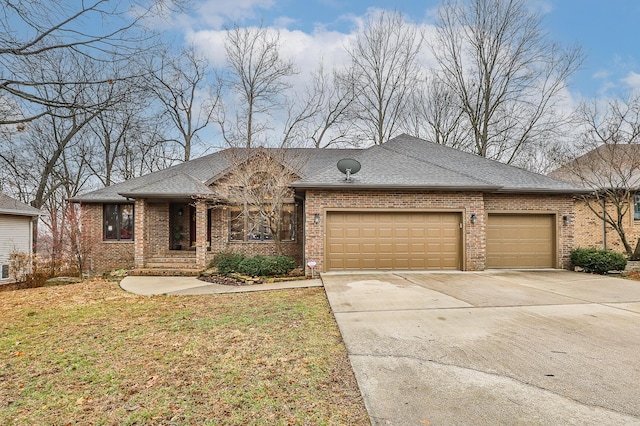 view of front of house with brick siding, an attached garage, and driveway