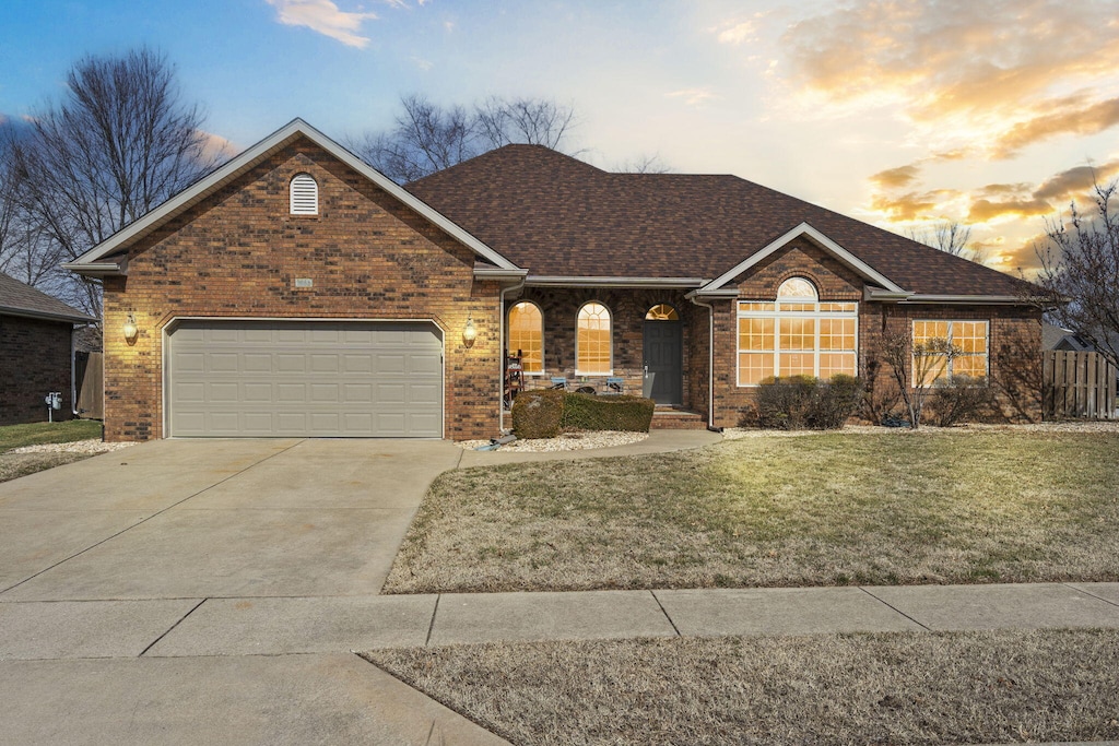 view of front of house with a yard and a garage