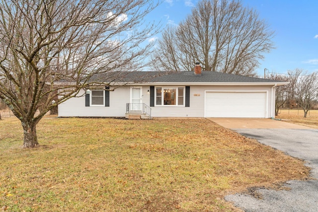 ranch-style home with a garage and a front lawn