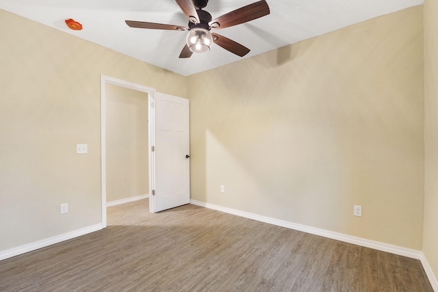 empty room with wood-type flooring and ceiling fan