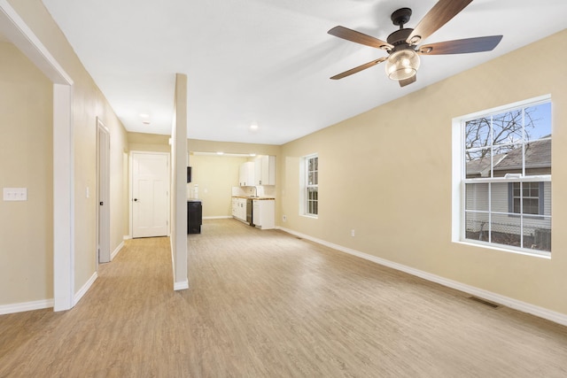 unfurnished living room featuring ceiling fan and light hardwood / wood-style flooring