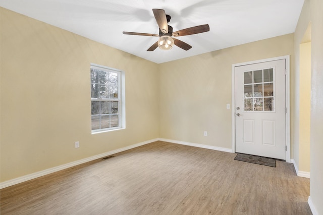 spare room featuring ceiling fan and light hardwood / wood-style flooring