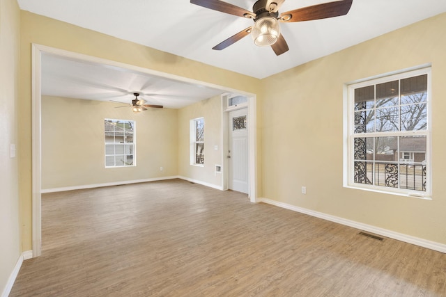 unfurnished room featuring hardwood / wood-style flooring and ceiling fan