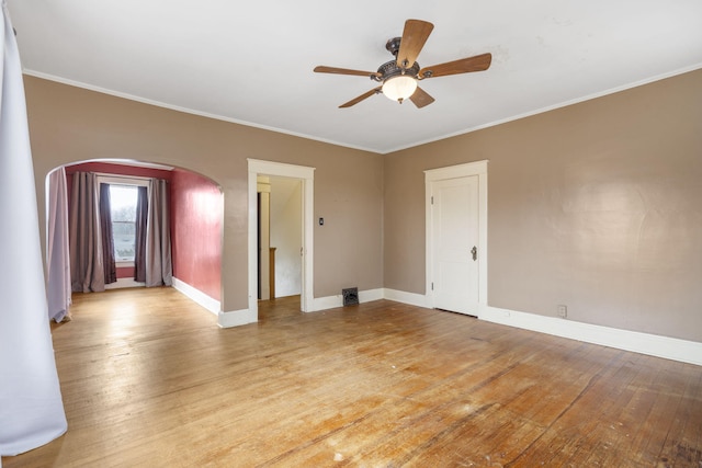 unfurnished room featuring ornamental molding, ceiling fan, and light wood-type flooring