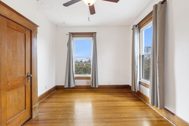 spare room with ceiling fan and light wood-type flooring