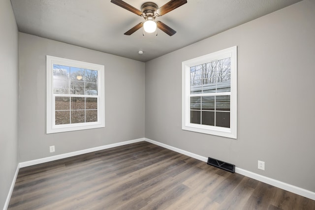 unfurnished room with dark hardwood / wood-style floors and ceiling fan