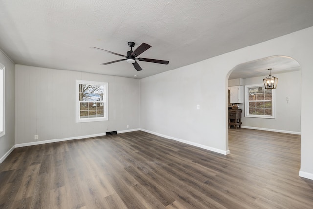 unfurnished room featuring dark hardwood / wood-style floors, a textured ceiling, and ceiling fan