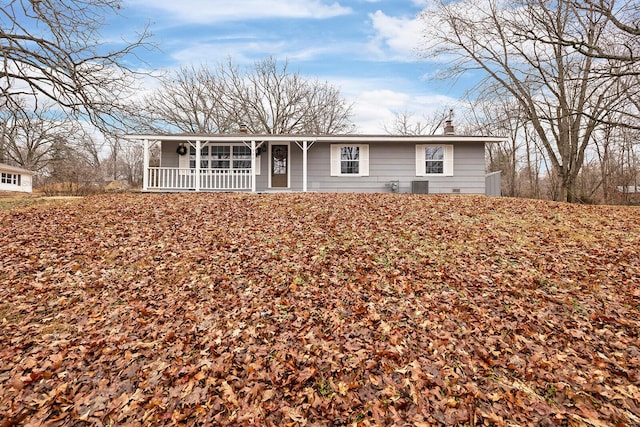 ranch-style home with a porch and cooling unit