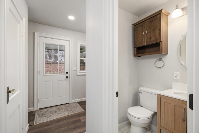 bathroom with vanity, hardwood / wood-style floors, and toilet