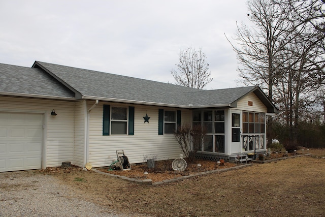 single story home with a garage and a sunroom