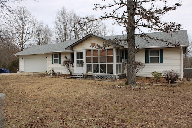 ranch-style house featuring a garage and a sunroom