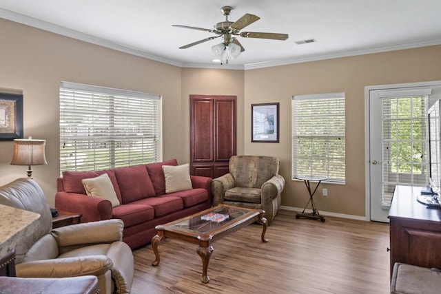 living room featuring ceiling fan, ornamental molding, and light hardwood / wood-style flooring