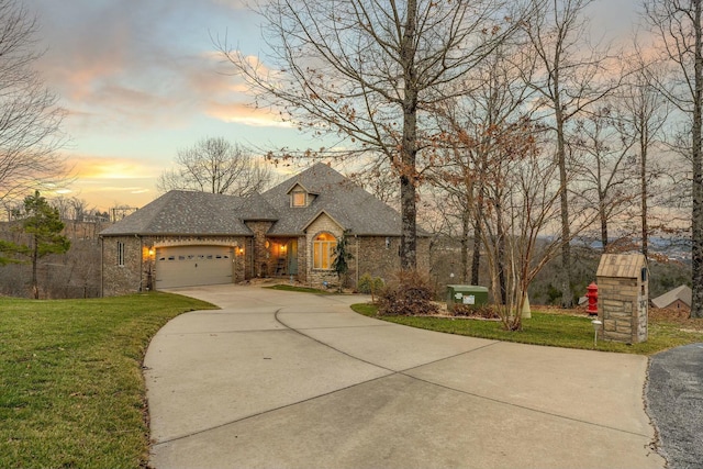 view of front of house featuring a garage and a yard