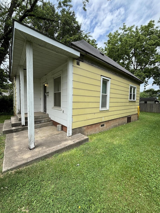 view of side of property with a yard