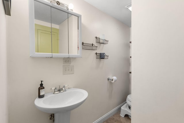 bathroom with sink, tile patterned floors, and toilet