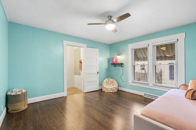 sitting room with ceiling fan and dark hardwood / wood-style flooring