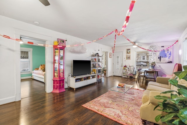 living room with ceiling fan and dark hardwood / wood-style floors