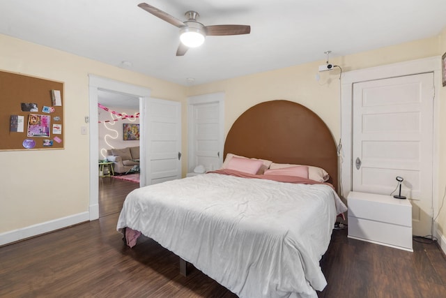 bedroom with dark hardwood / wood-style floors and ceiling fan