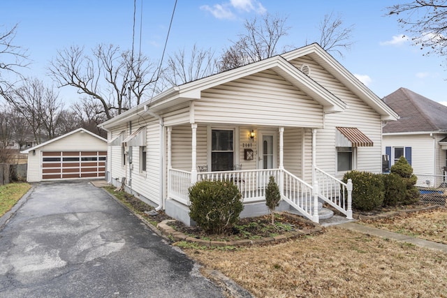 view of front of house featuring a garage, an outdoor structure, and covered porch