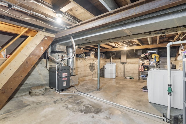 basement with heating unit and washing machine and clothes dryer