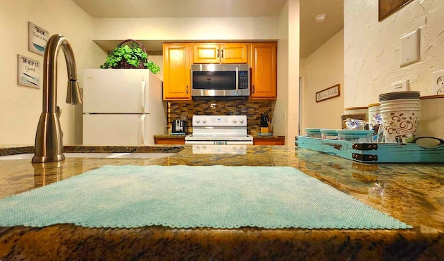 kitchen with tasteful backsplash, appliances with stainless steel finishes, and sink