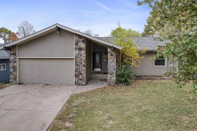 ranch-style home with a garage and a front lawn