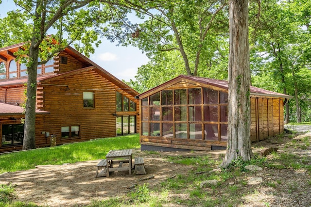 241 Nine Center Ct, Reeds Spring, MO 65737 - rear view of house featuring a sunroom