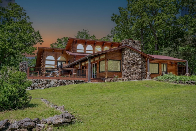 241 Nine Center Ct, Reeds Spring, MO 65737 - back of house at dusk with a yard, a chimney, and log exterior
