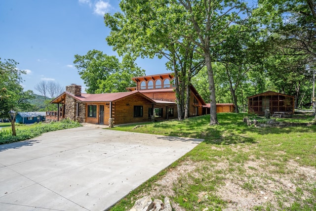 241 Nine Center Ct, Reeds Spring, MO 65737 - log-style house featuring a chimney, stone siding, a front yard, and metal roof