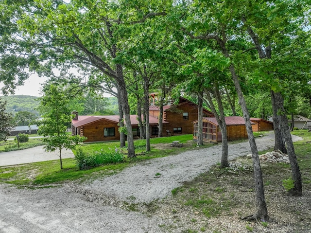 241 Nine Center Ct, Reeds Spring, MO 65737 - view of front of home featuring concrete driveway, a chimney, and a front yard