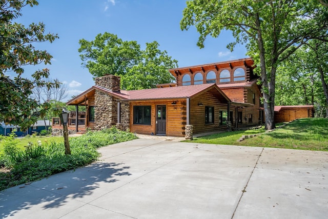 241 Nine Center Ct, Reeds Spring, MO 65737 - log-style house featuring a chimney, a front lawn, metal roof, and log siding