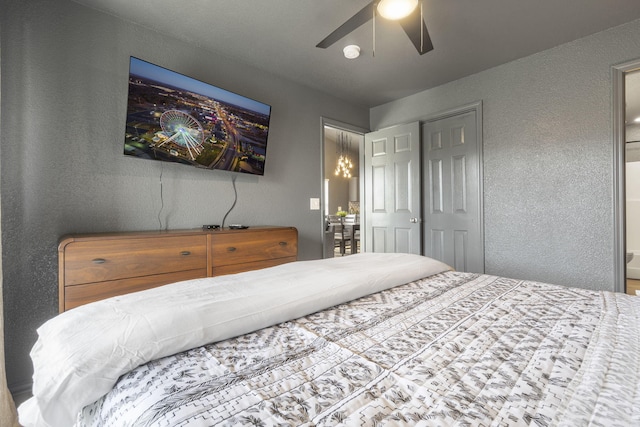 bedroom with ceiling fan and a closet