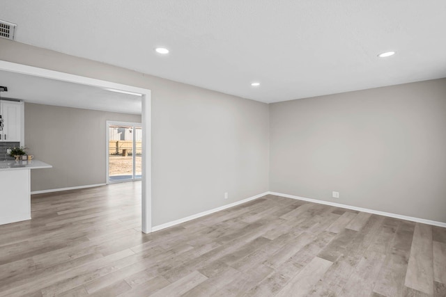 spare room with visible vents, recessed lighting, baseboards, and light wood finished floors