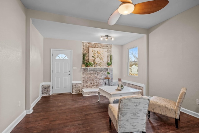 living area with dark hardwood / wood-style floors and ceiling fan