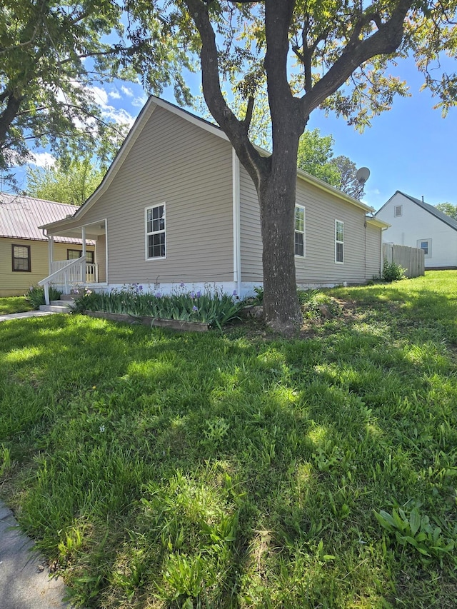 312 Frisco St, Monett, MO 65708 - view of home's exterior featuring a lawn and a porch