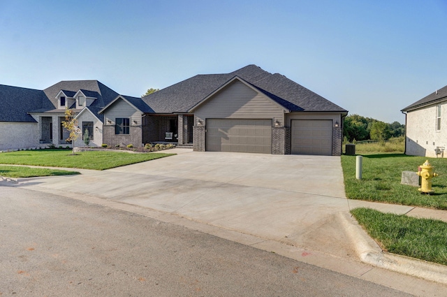 view of front of property with a garage and a front lawn