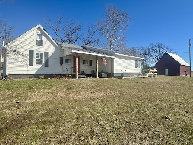 rear view of property featuring a yard