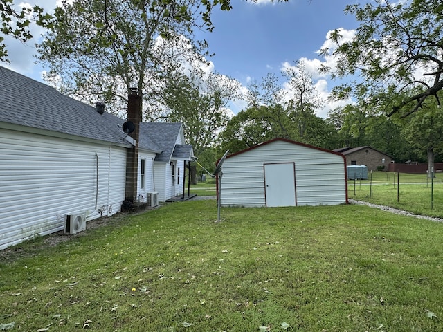 view of yard with a storage shed, an outbuilding, central AC unit, and ac unit