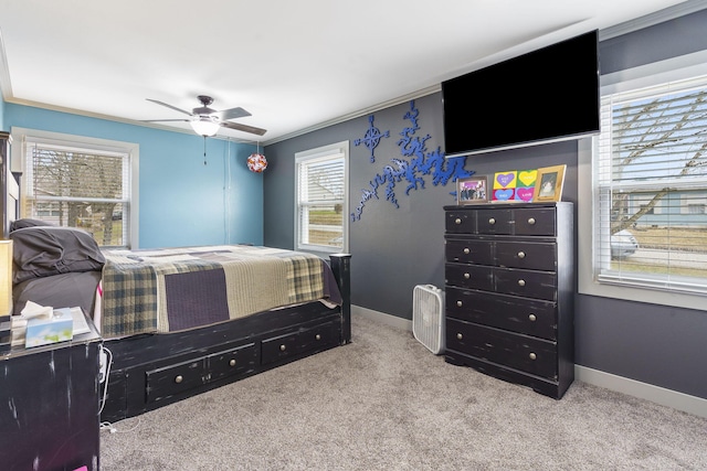 bedroom featuring crown molding, light carpet, and ceiling fan