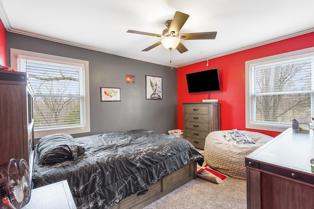 bedroom with ornamental molding, carpet, and ceiling fan