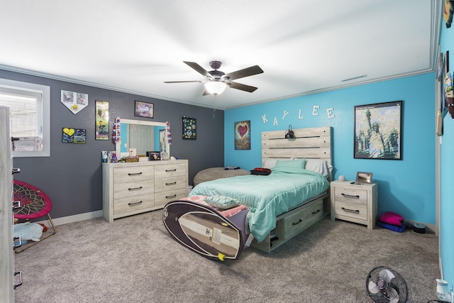 carpeted bedroom with ceiling fan and ornamental molding