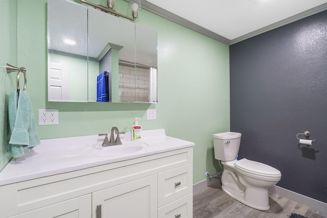 bathroom featuring crown molding, vanity, toilet, and hardwood / wood-style flooring