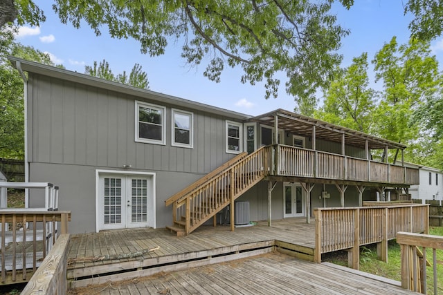 back of property with a wooden deck and french doors