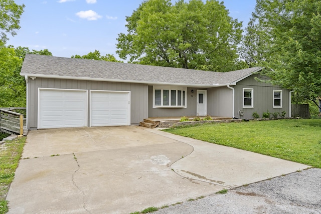 ranch-style house featuring a garage and a front yard