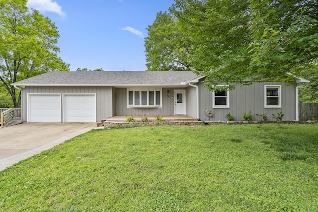 ranch-style house featuring a garage and a front yard